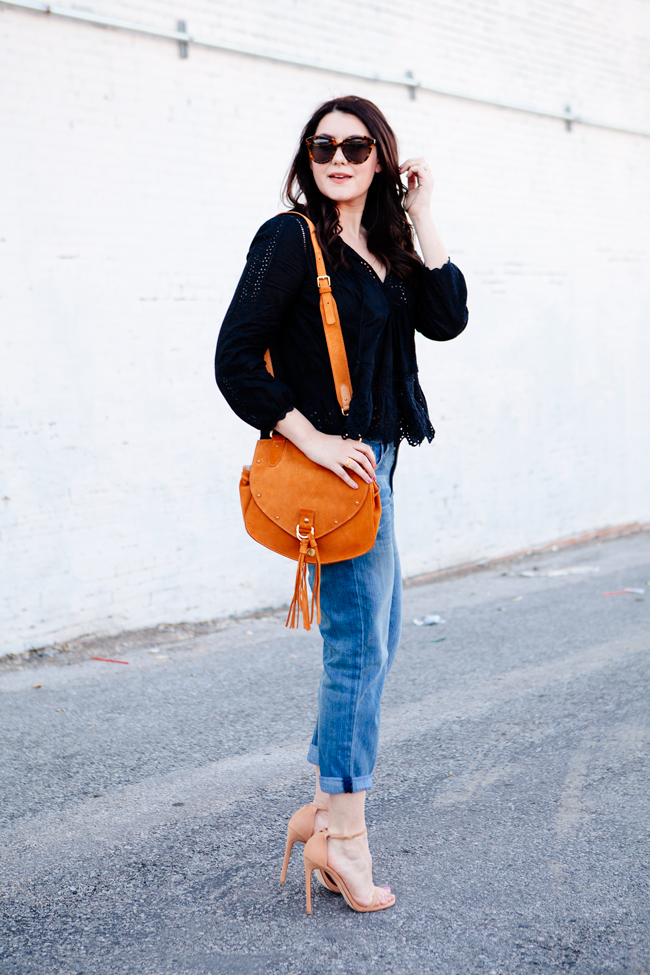 Black eyelet top paired with boyfriend jeans on Kendi Everyday