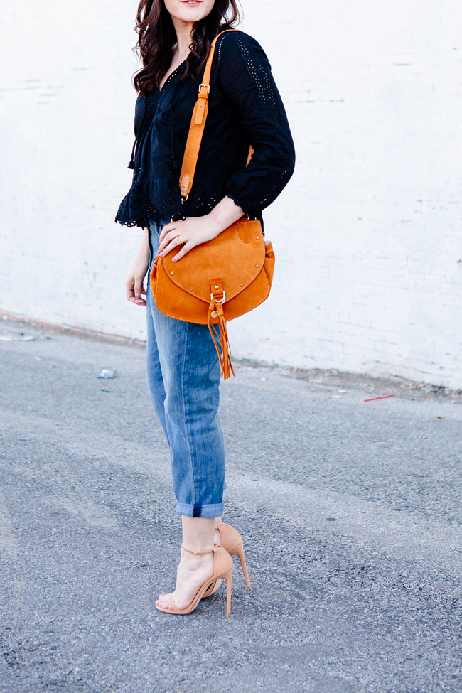 Black eyelet top paired with boyfriend jeans on Kendi Everyday