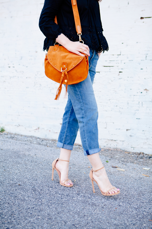 Black eyelet top paired with boyfriend jeans on Kendi Everyday