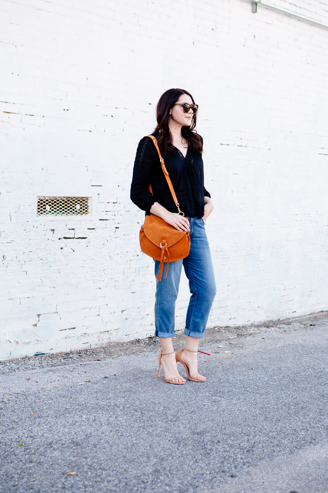 Black eyelet top paired with boyfriend jeans on Kendi Everyday