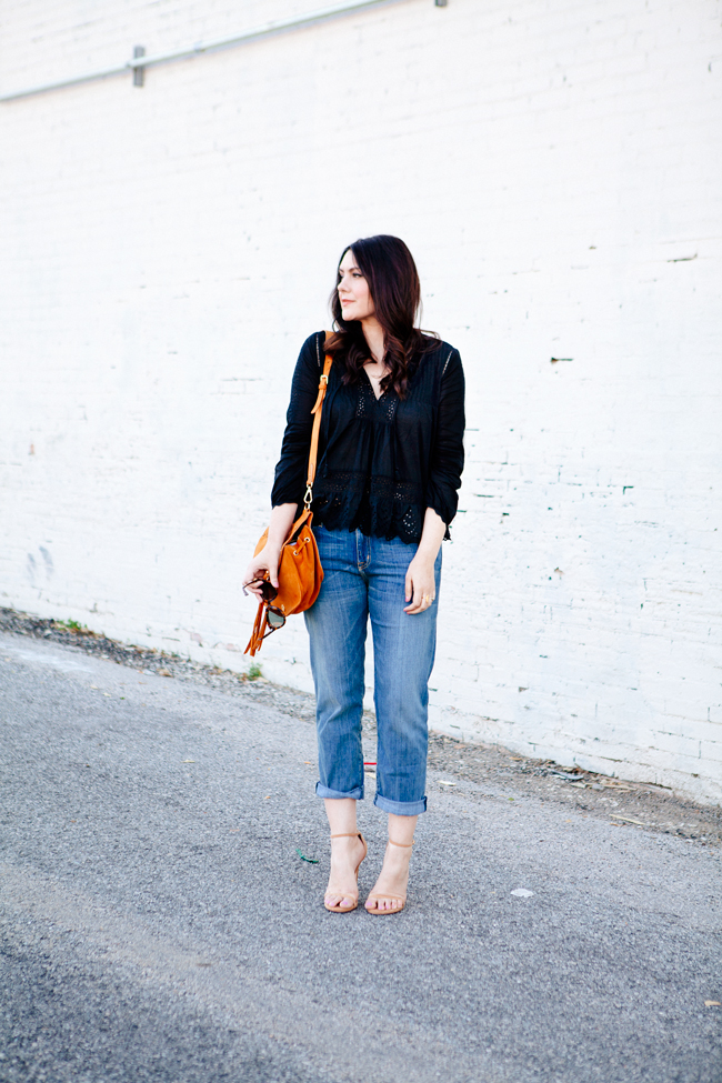 Black eyelet top paired with boyfriend jeans on Kendi Everyday
