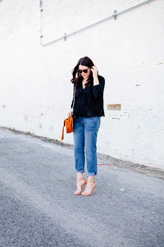 Black eyelet top paired with boyfriend jeans on Kendi Everyday