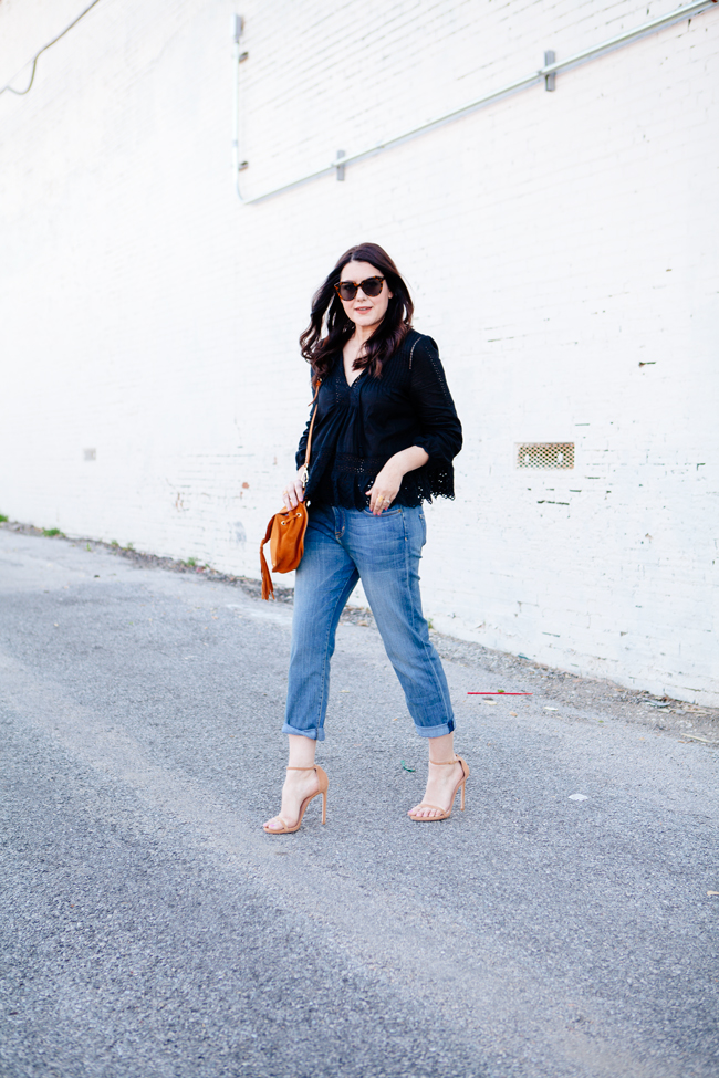 Black eyelet top paired with boyfriend jeans on Kendi Everyday