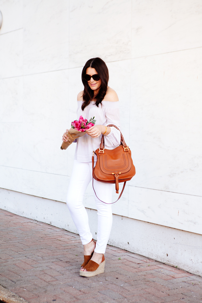 Off the shoulder top and white skinny jeans on Kendi Everyday