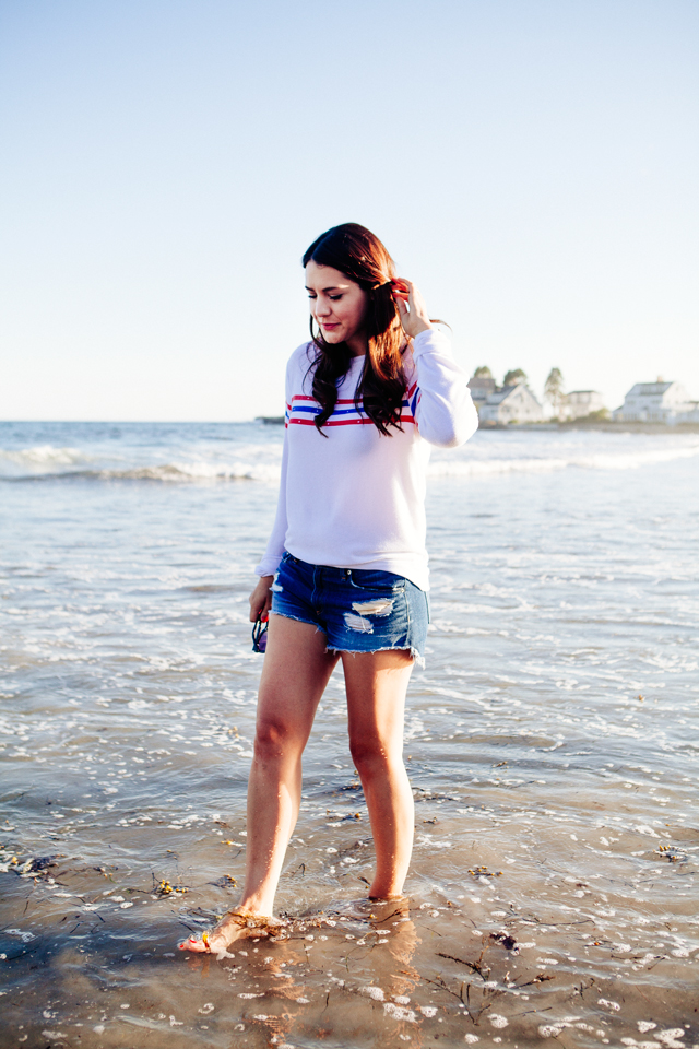 Kendi Everyday wearing a Wildfox Striped Sweatshirt and denim cut Offs on the beach