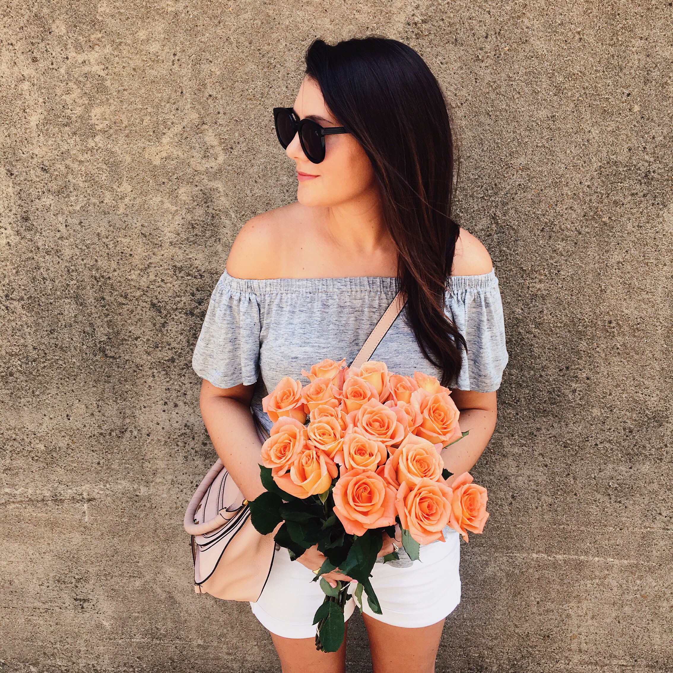 Grey off the shoulder top with white cut-offs and orange roses on Kendi Everyday.