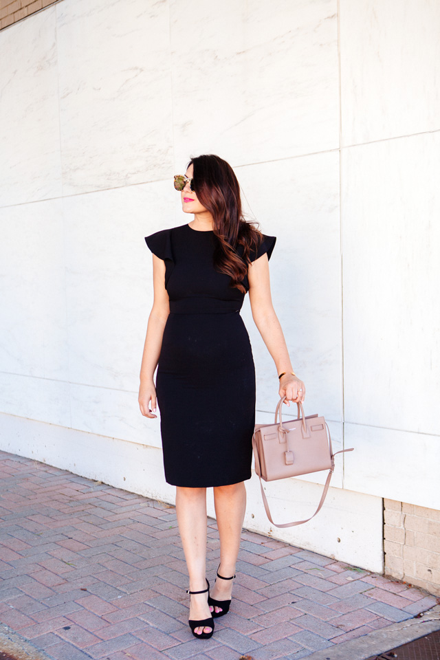 Kendi Everyday in Little Black Dress with Ruffle Sleeves. 