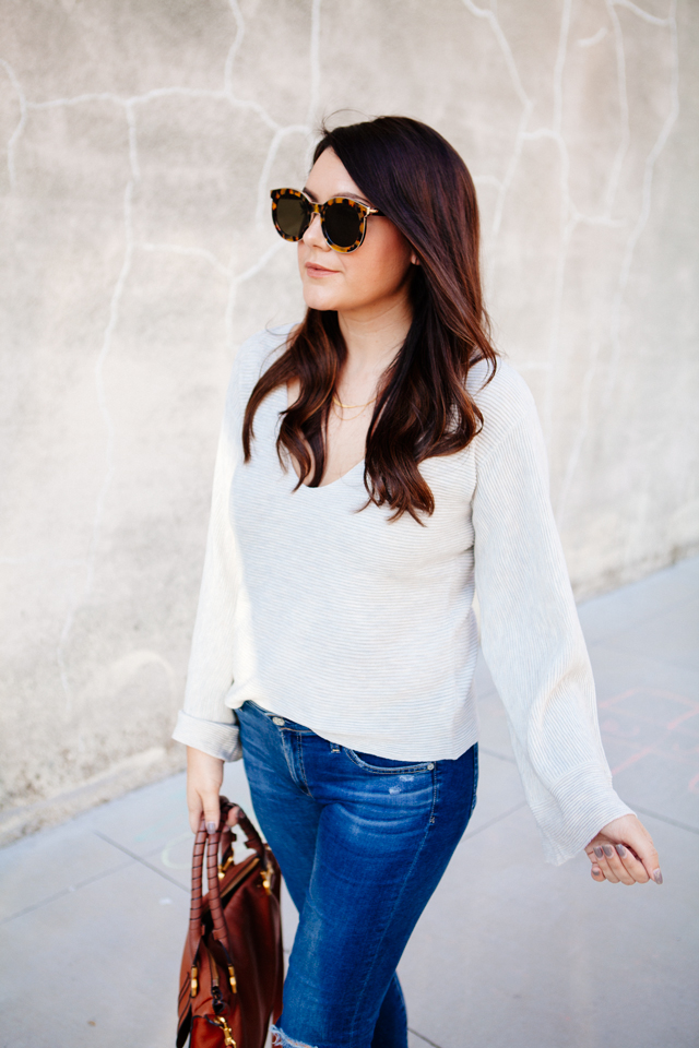 Bell sleeve sweater with skinny jeans and cognac accessories. 