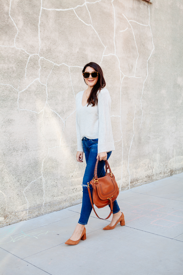 Bell sleeve sweater with skinny jeans and cognac accessories. 