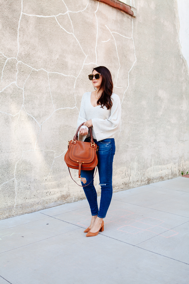 Bell sleeve sweater with skinny jeans and cognac accessories. 