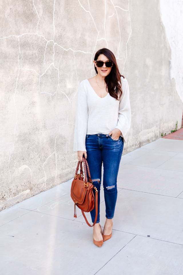 Bell sleeve sweater with skinny jeans and cognac accessories. 