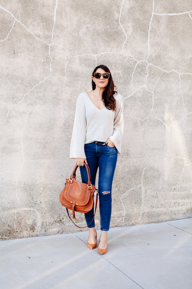 Bell sleeve sweater with skinny jeans and cognac accessories. 