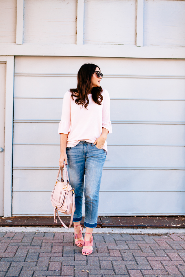 Pink Bell sleeve sweater with raw edge denim and madewell tassel pink suede heels.