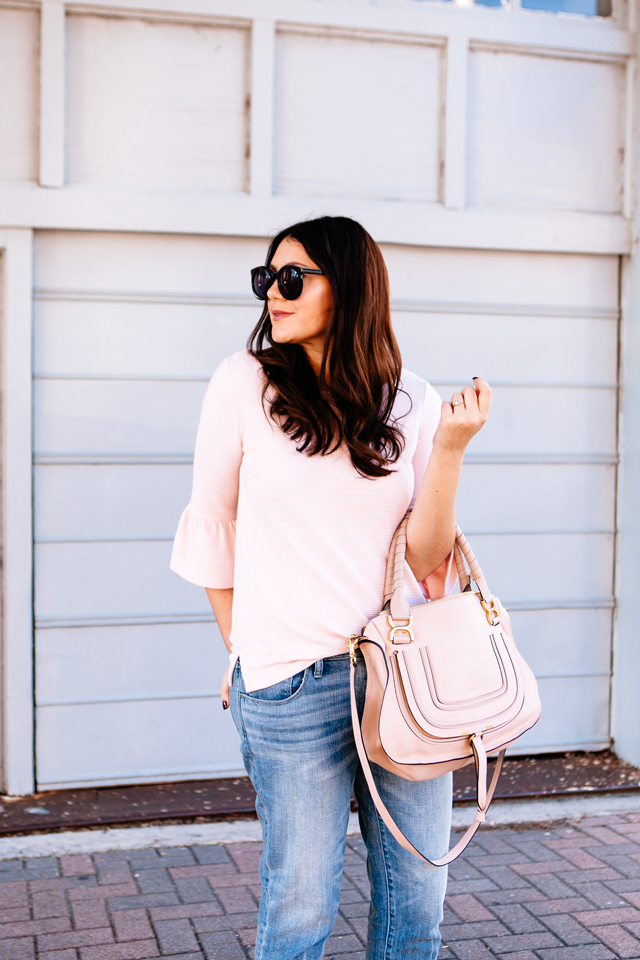 Pink Bell sleeve sweater with raw edge denim and madewell tassel pink suede heels.