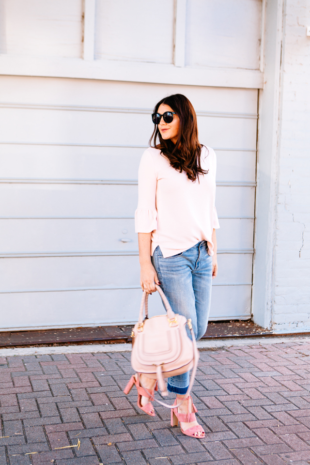 Pink Bell sleeve sweater with raw edge denim and madewell tassel pink suede heels.