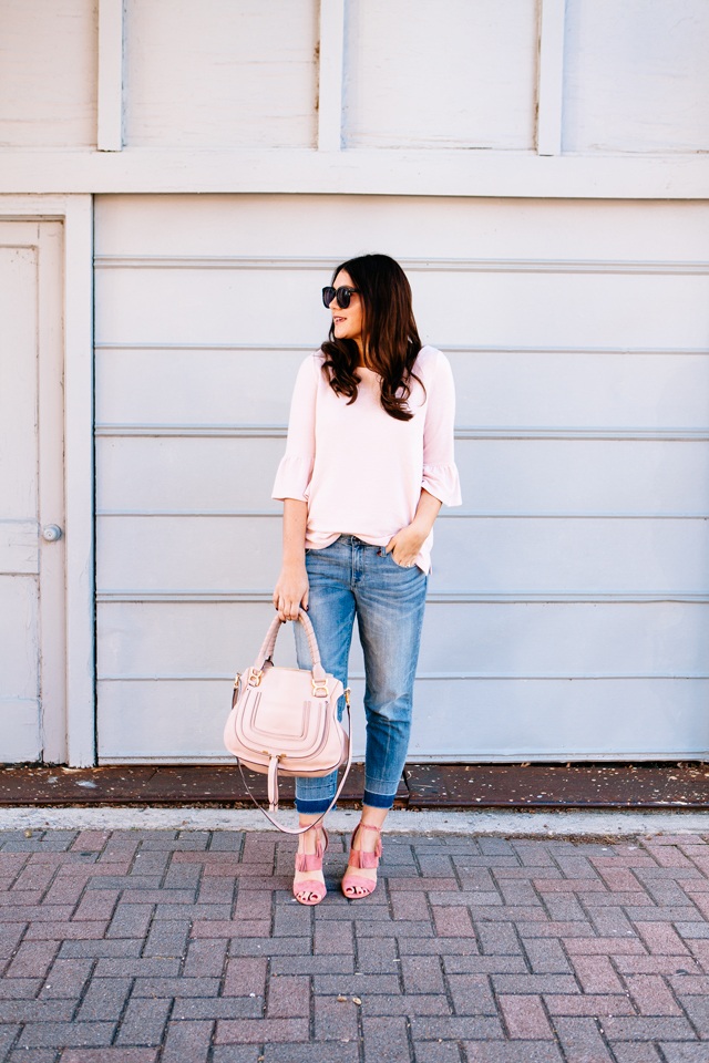 Pink Bell sleeve sweater with raw edge denim and madewell tassel pink suede heels.