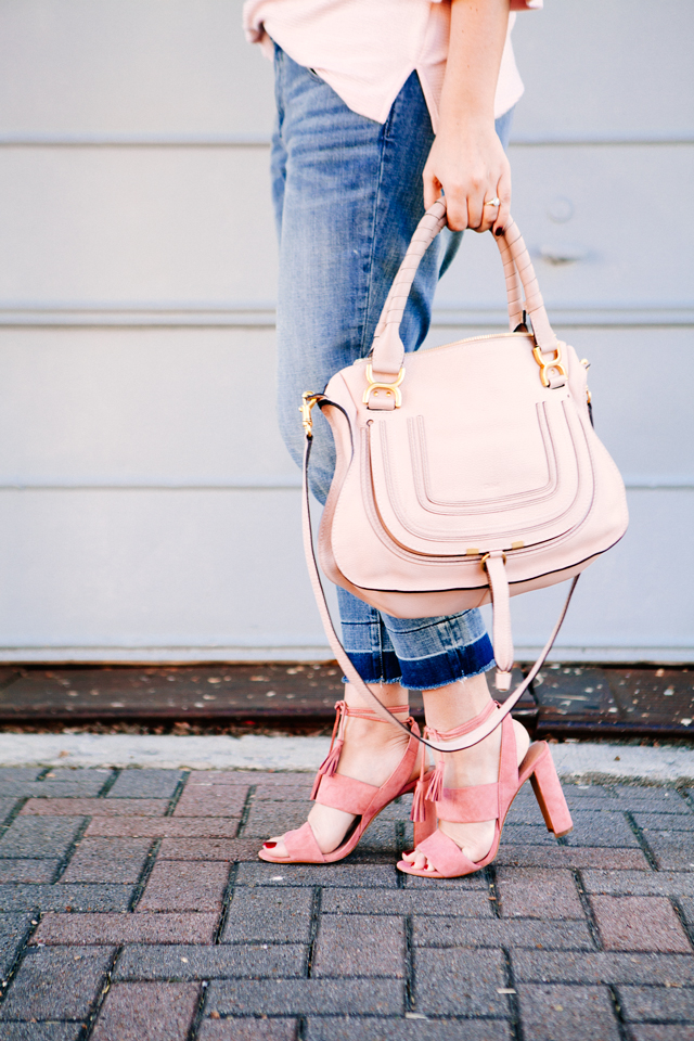 Pink Bell sleeve sweater with raw edge denim and madewell tassel pink suede heels.