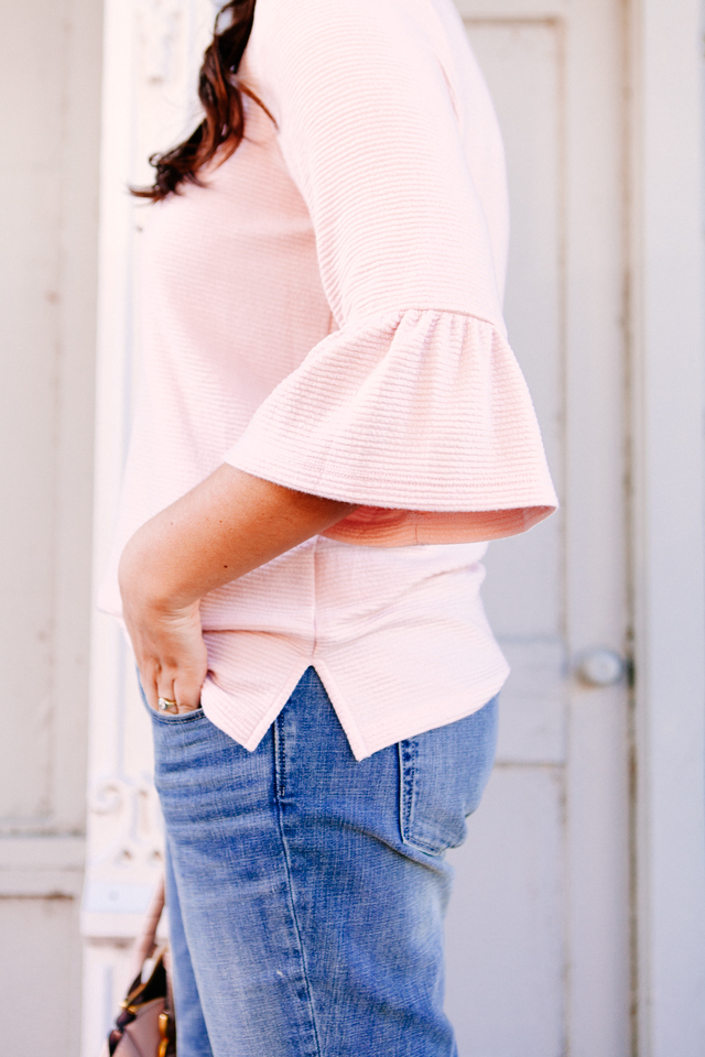 Pink Bell sleeve sweater with raw edge denim and madewell tassel pink suede heels.