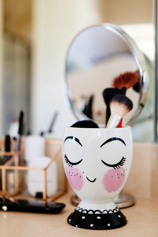 Painted lady ceramic cup for makeup brushes.