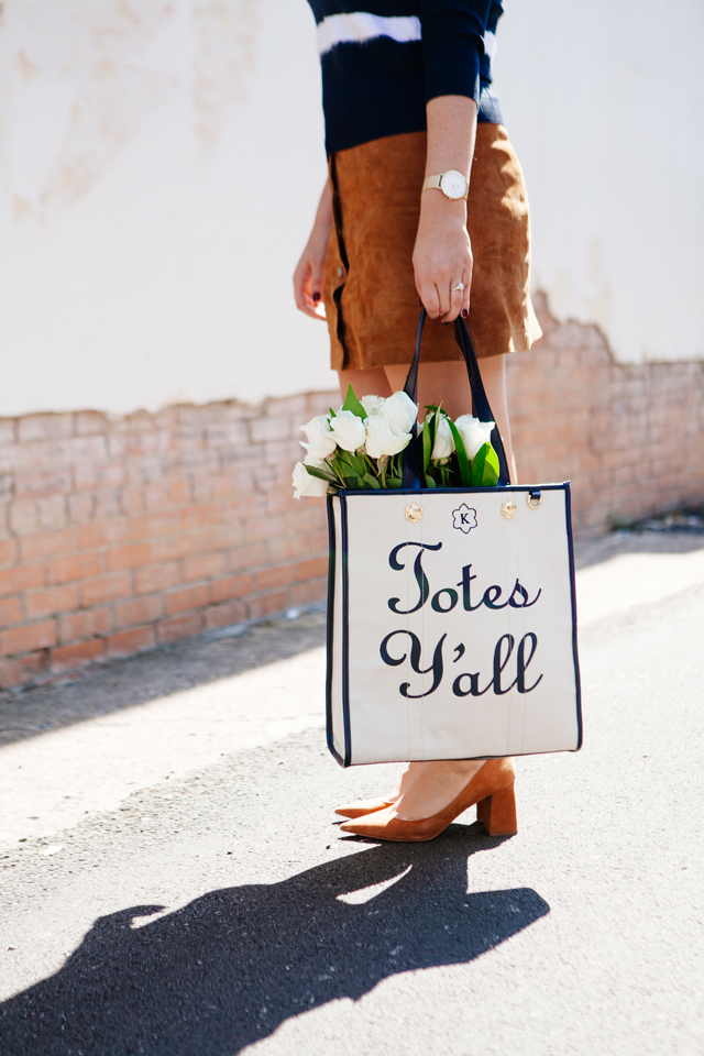 Striped sweater with suede mink skirt and tote with flowers on Kendi Everyday