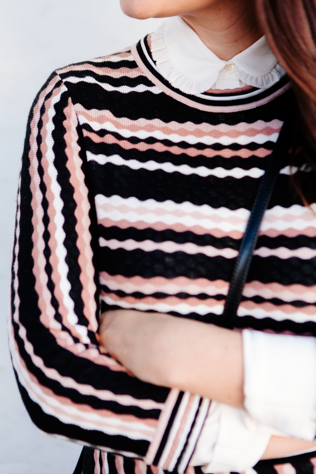 Kate Spade sweater dress with ruffle collar shirt and black cross body purse. 