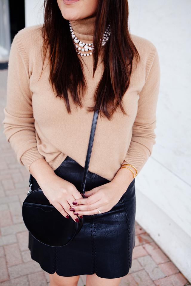 Cowl neck sweater and layered peal necklace with faux leather skirt.