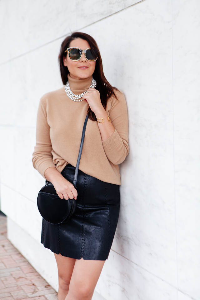 Cowl neck sweater and layered peal necklace with faux leather skirt.