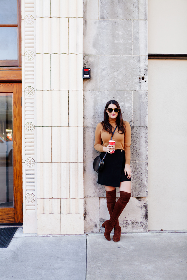 Fall outfit featuring camel turtleneck with black wrap skirt and over the knee boots. 