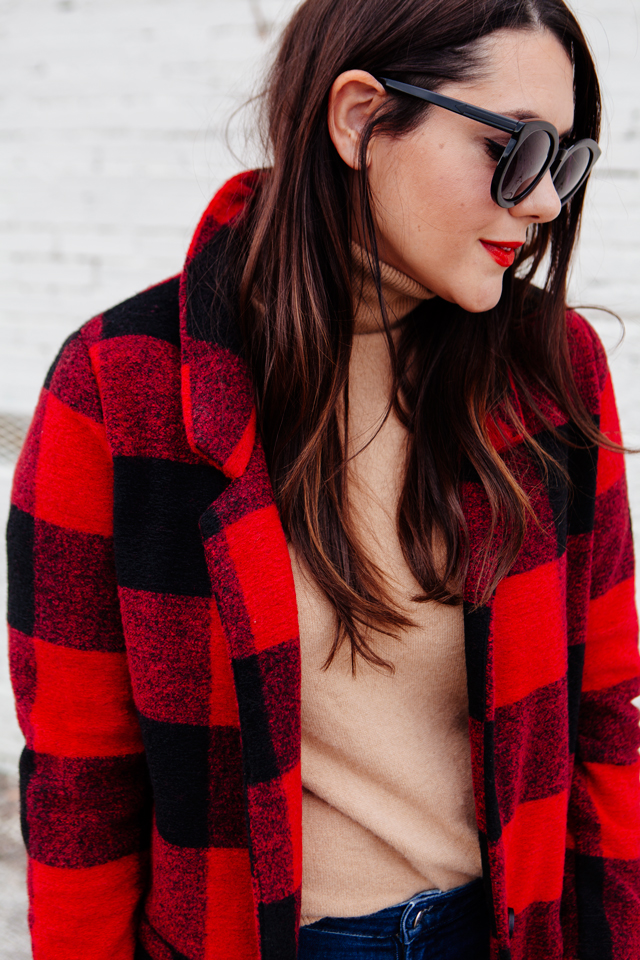 Buffalo plaid jacket with camel sweater and black heels on Kendi Everyday.