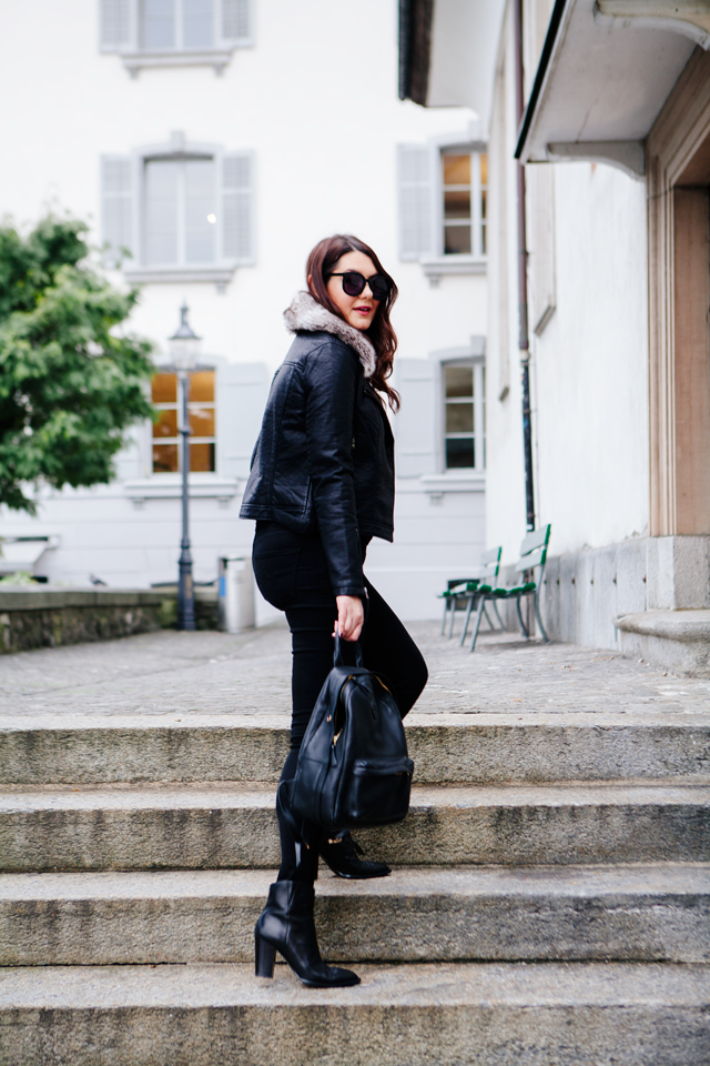 Black moto jacket with fur collar and black denim on Kendi Everyday