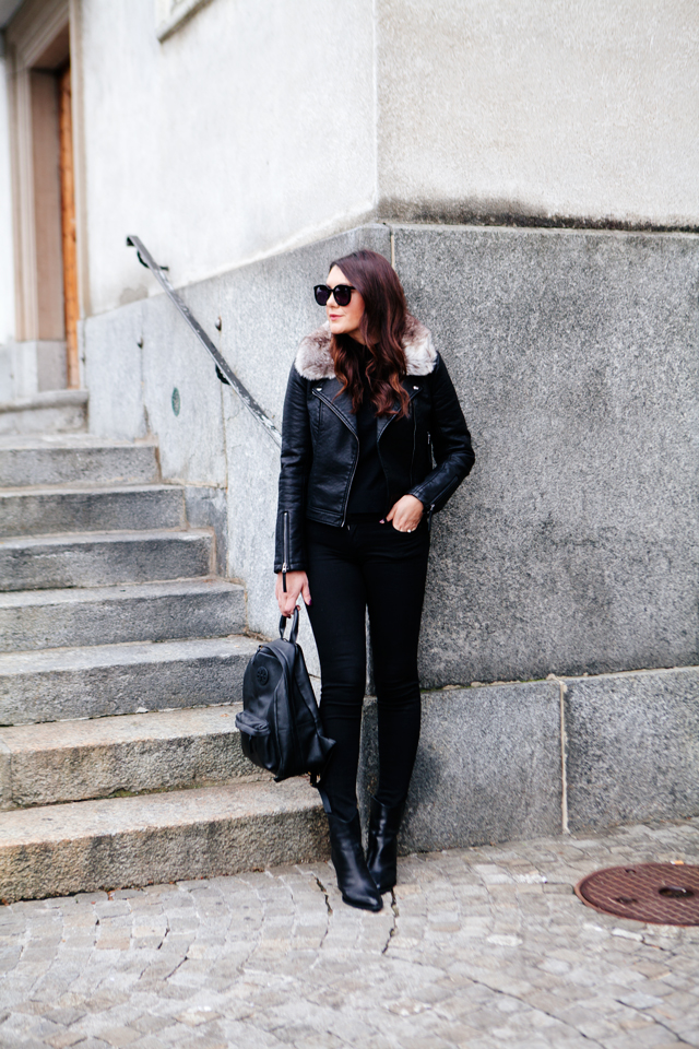 Black moto jacket with fur collar and black denim on Kendi Everyday