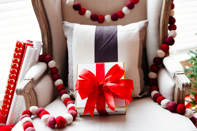 Ribbon pinch bow on chair with Christmas garland.