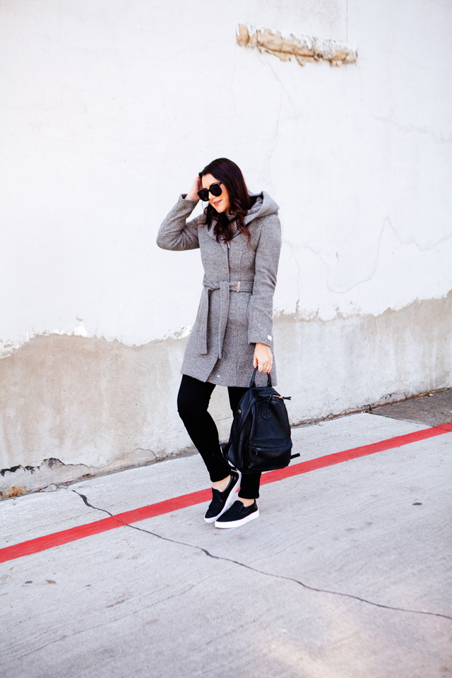 Holiday travel outfit with sneaks and backpack.