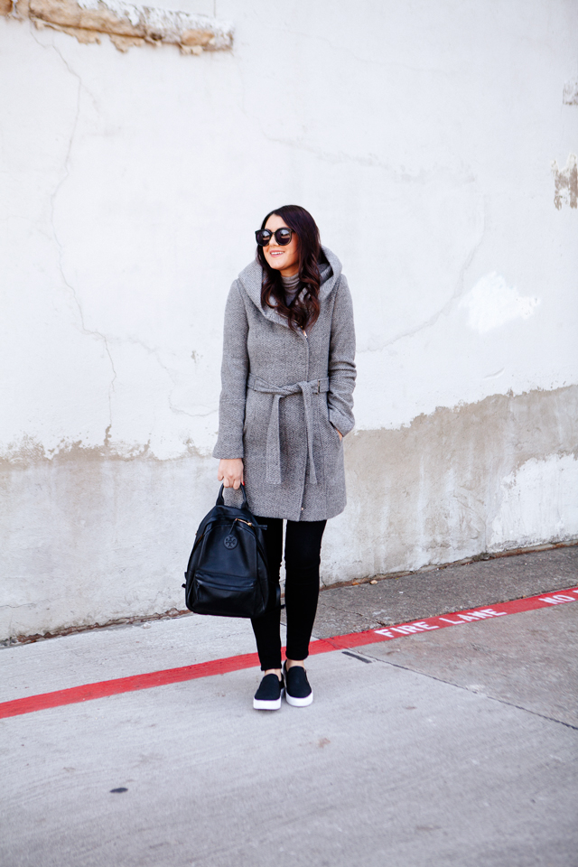 Holiday travel outfit with sneaks and backpack.