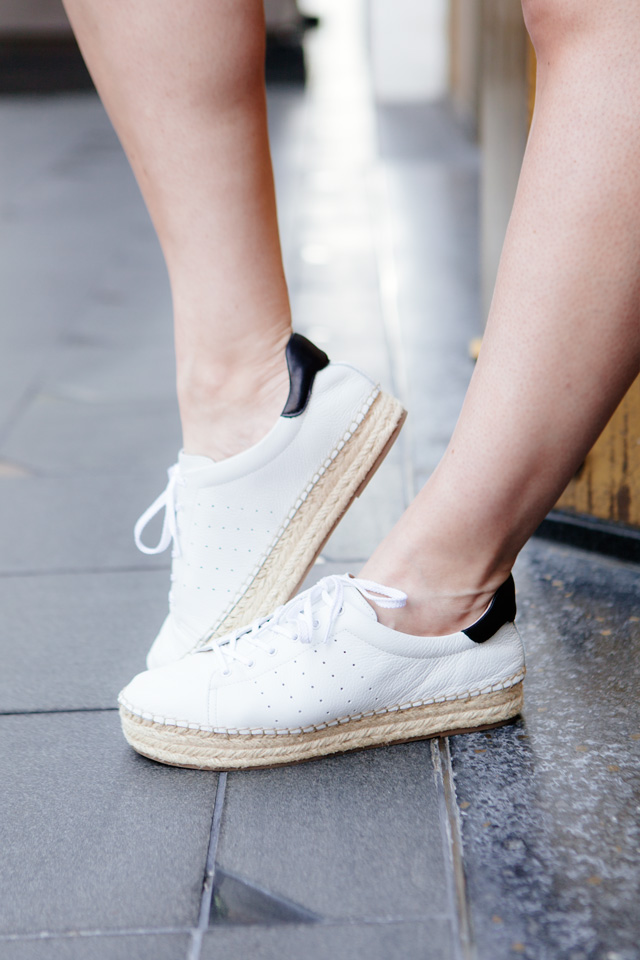 white off the shoulder top with cut offs and espadrille sneakers