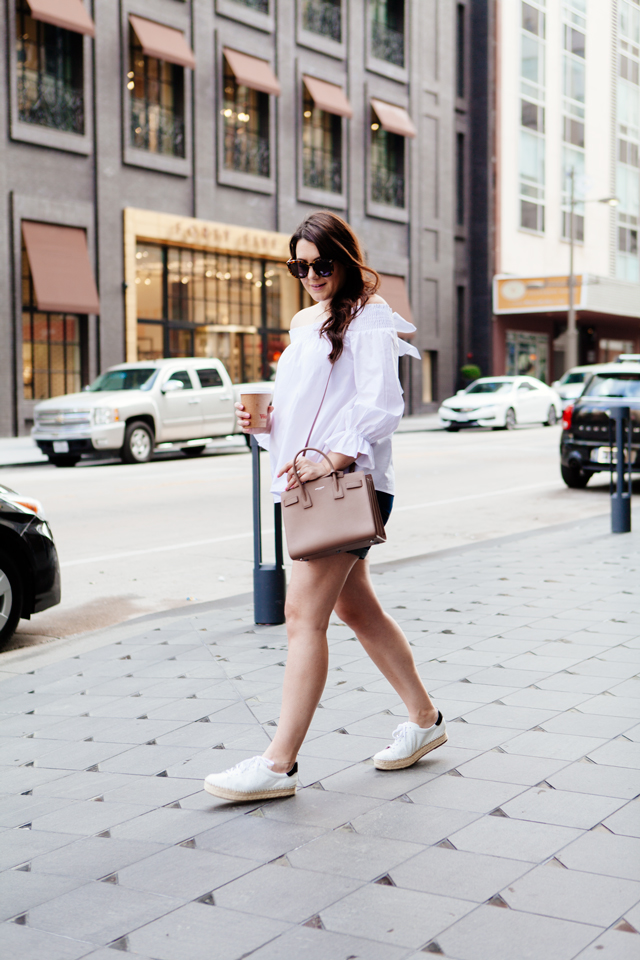 white off the shoulder top with cut offs and espadrille sneakers