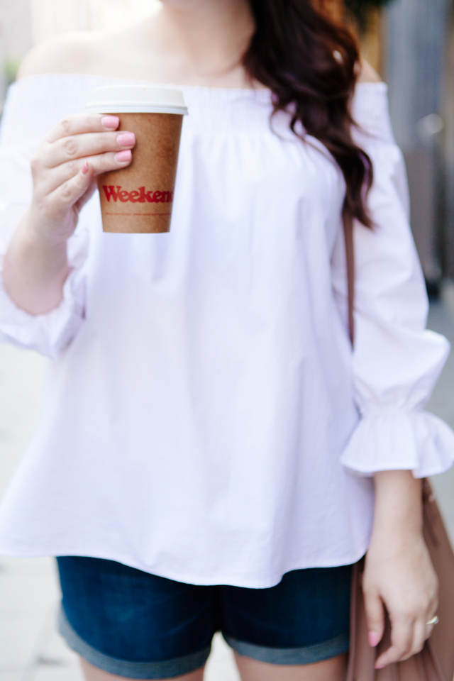 white off the shoulder top with cut offs and espadrille sneakers