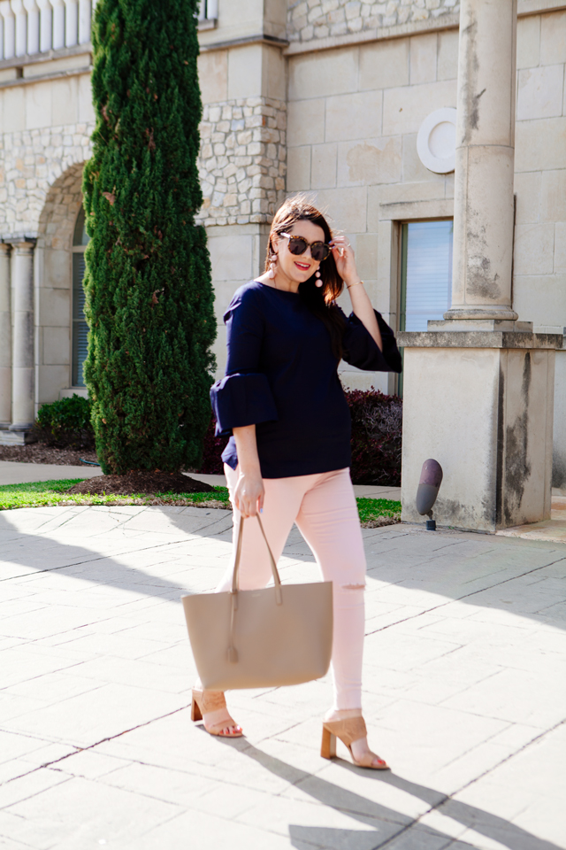 Bell sleeve top with pale pink skinny jeans.