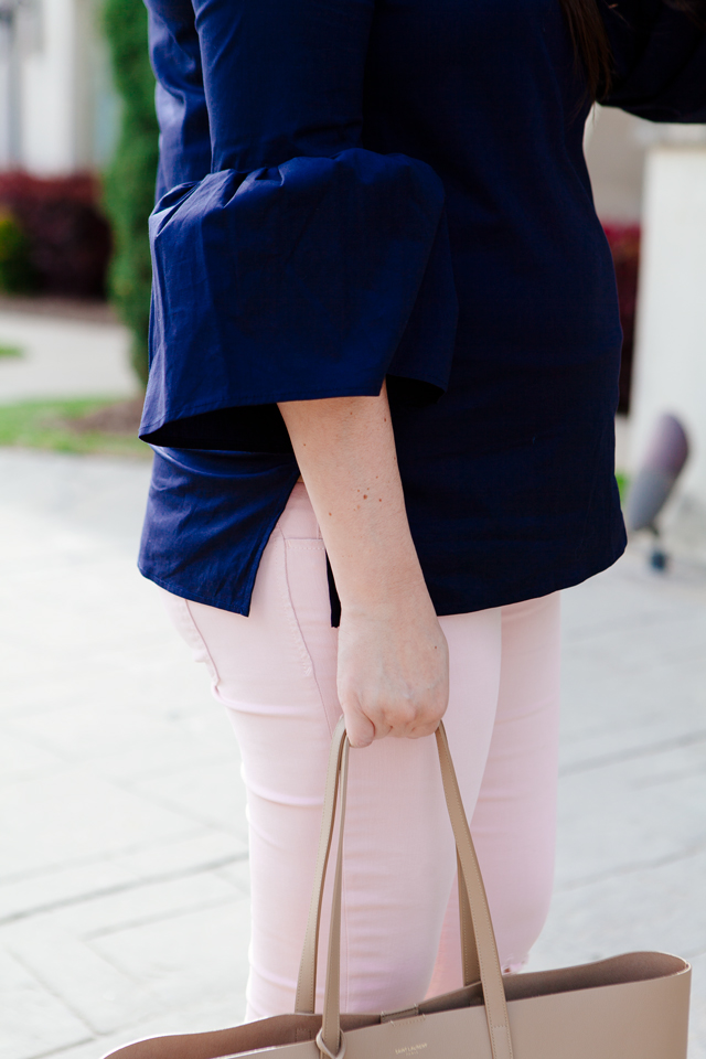 Bell sleeve top with pale pink skinny jeans.