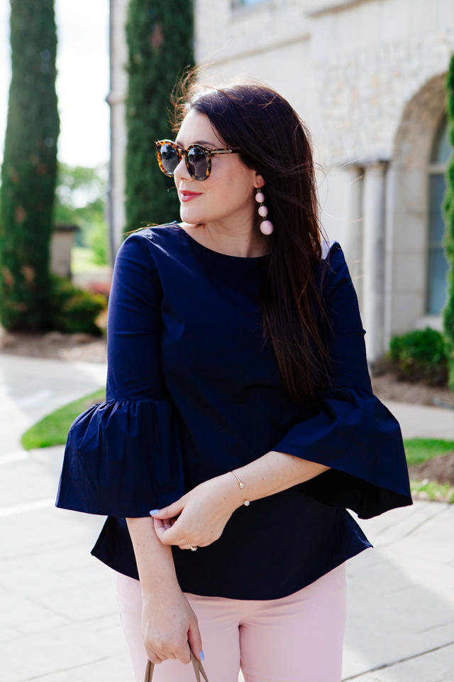 Bell sleeve top with pale pink skinny jeans.