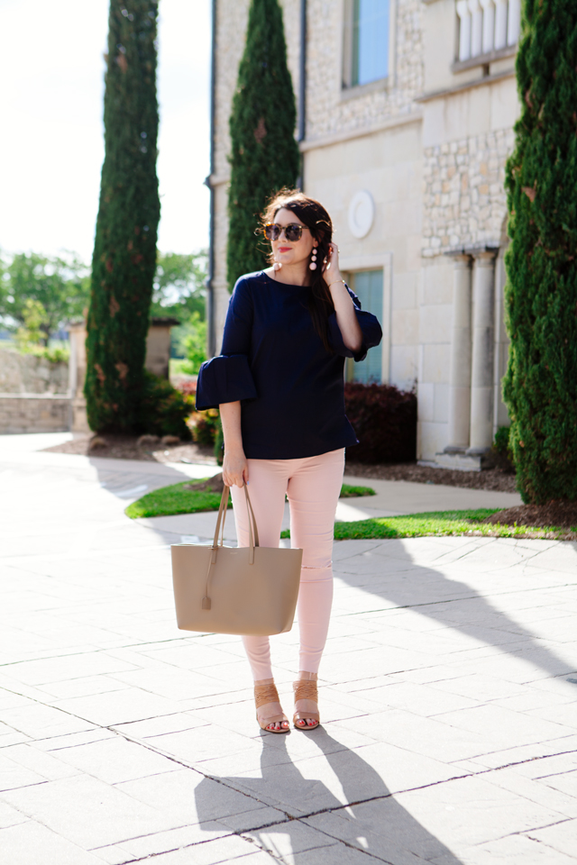 Bell sleeve top with pale pink skinny jeans.