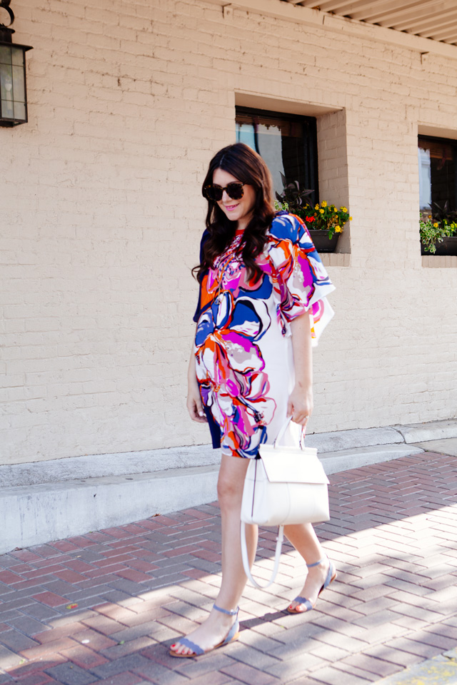 Silk floral dress with white handbag