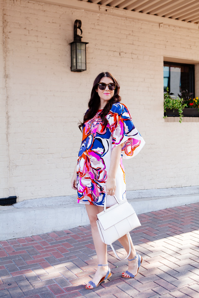 Silk floral dress with white handbag