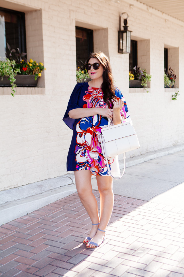 Silk floral dress with white handbag